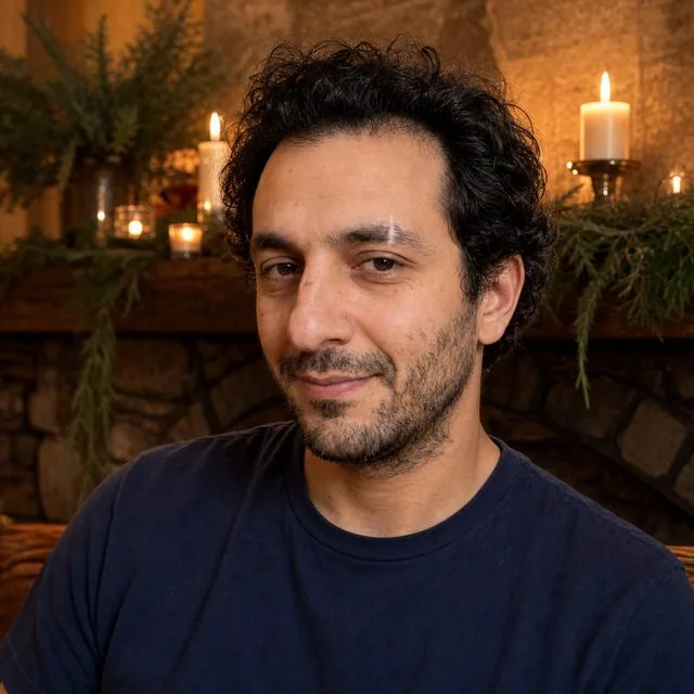 Christmas card: a warm frame in front of a mantelpiece with candles and garland, gentle smile