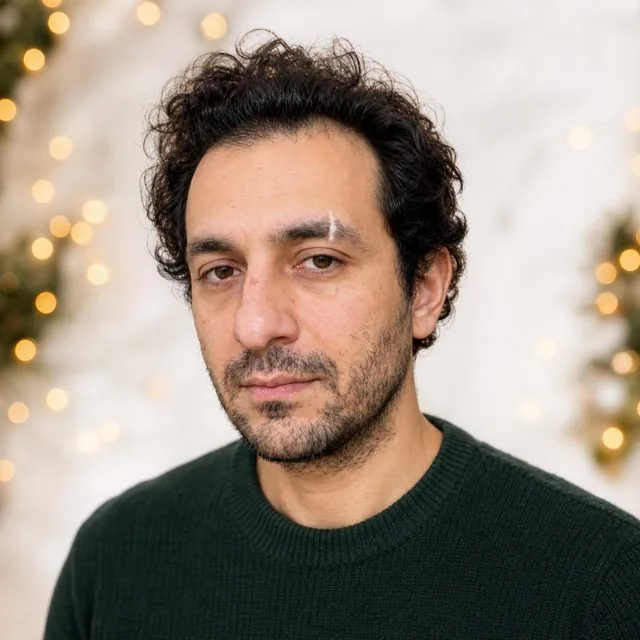 Christmas card: a bright card-style shot against a white wall with subtle gold bokeh, festive styling