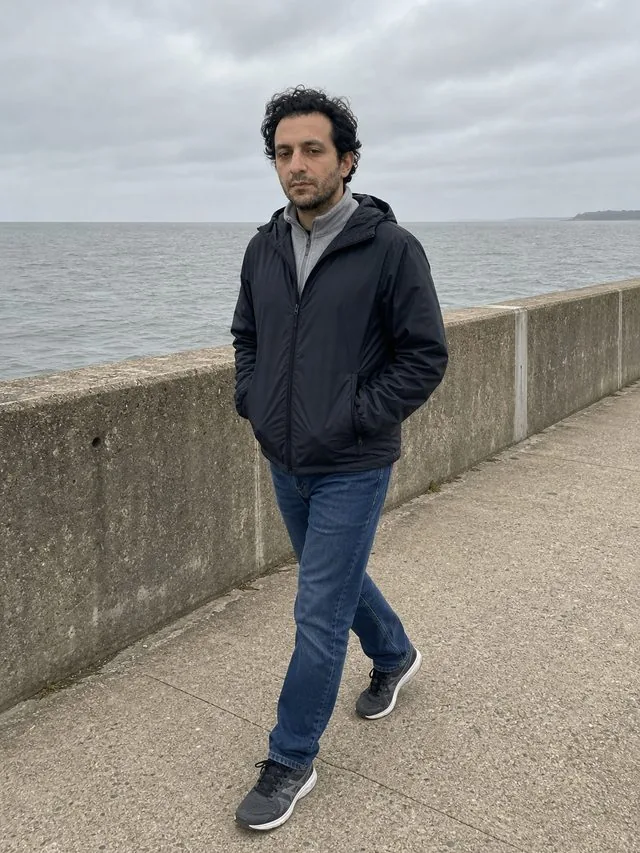 Coastal technical: a full-length frame from head to toe with the entire figure and both shoes inside the frame