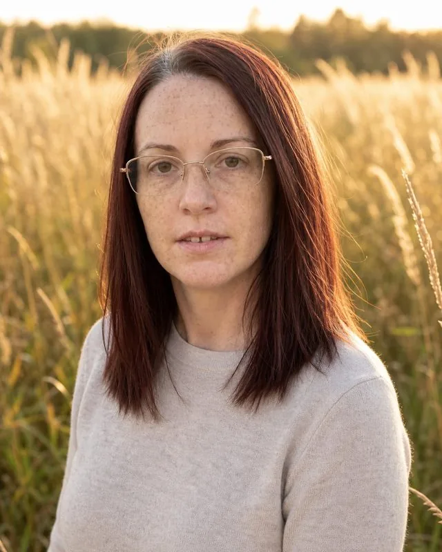 Engagement shoot: in a meadow at golden hour in soft neutral clothing, long grass catching the light