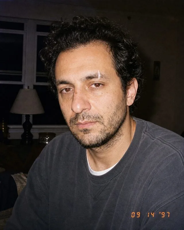 1990s: a 1990s point-and-shoot frame with harsh on-camera flash, baggy clothing, date stamp in the corner