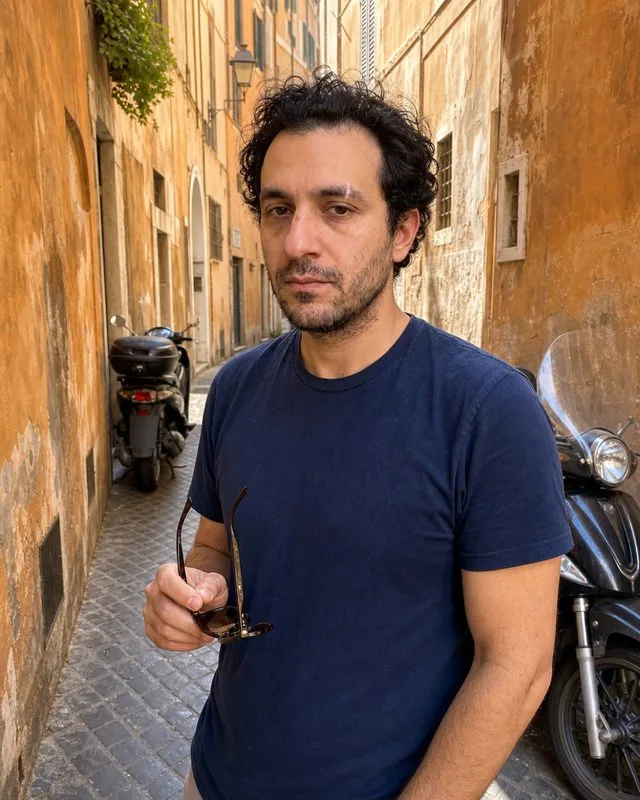 Rome: in a narrow ochre-walled lane with scooters parked along it, warm afternoon light, sunglasses in hand