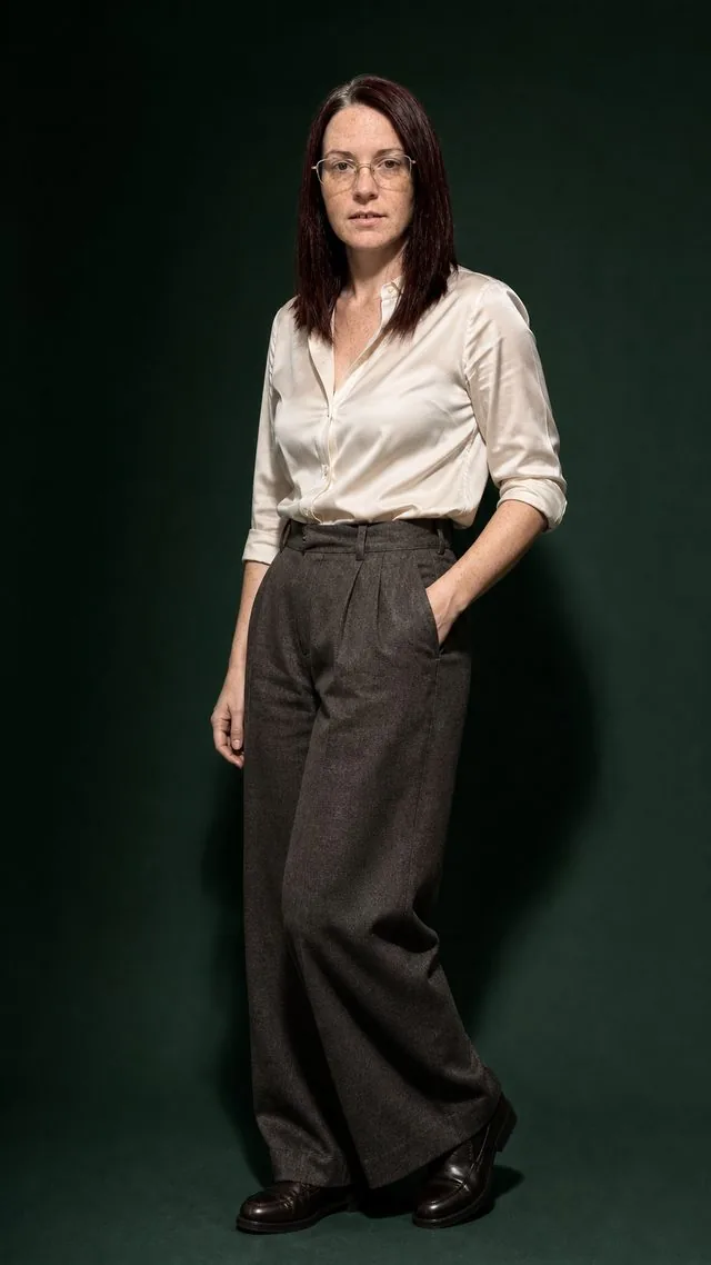 Editorial full figure: the whole figure in a strong contrapposto against a deep green backdrop