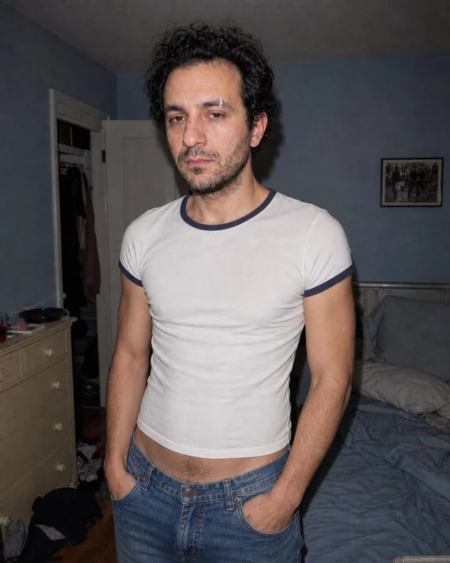 Y2K: a early-2000s styled frame with a compact digital camera flash, low-rise denim and a baby tee, bedroom behind
