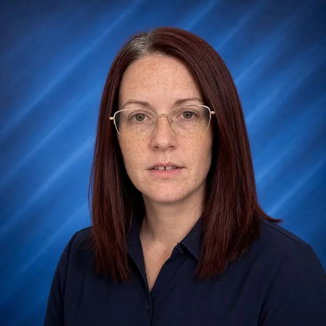 Yearbook: a school yearbook portrait against a blue laser backdrop, soft studio light, formal collared clothing